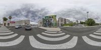 an intersection view looking toward the sky and buildings in the background from the 360 - angle view point on a street