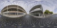 a couple of distorted pictures are on a floor outdoors, with sky reflected in them