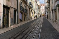 an image of a street in europe where the tracks are not parallel at all points