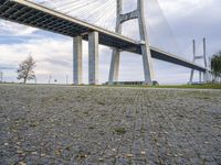 a street sign in front of the bridge and other structures above it with a sky background