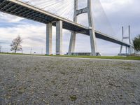 a street sign in front of the bridge and other structures above it with a sky background