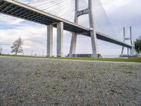 a street sign in front of the bridge and other structures above it with a sky background