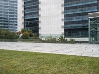 a person walking through the grass with a fire hydrant in hand and behind the building