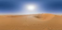 a desert scene with footprints in the sand as the sun goes down on the horizon