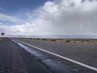 there is a lone highway with no traffic on it, but no cars on the side