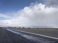 there is a lone highway with no traffic on it, but no cars on the side