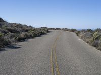 a lonely street with no traffic is shown on this sunny day in the desert,