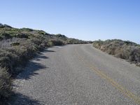 a lonely street with no traffic is shown on this sunny day in the desert,