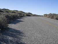 a lonely street with no traffic is shown on this sunny day in the desert,