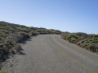 a lonely street with no traffic is shown on this sunny day in the desert,