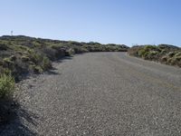 a lonely street with no traffic is shown on this sunny day in the desert,