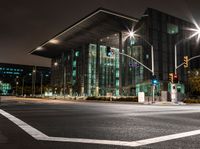 the city streets are lit by traffic lights and on the ground is the tall building