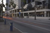 a street is empty as traffic approaches from a large building on the side of the road
