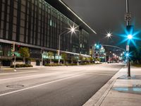 city street lights shine on an empty street in the night time at the intersection of two streets