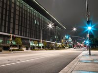 city street lights shine on an empty street in the night time at the intersection of two streets