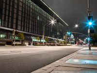 city street lights shine on an empty street in the night time at the intersection of two streets