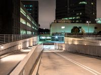 a person on an empty ramp with traffic lights on in a dark city area at night