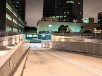 a person on an empty ramp with traffic lights on in a dark city area at night