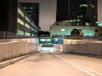 a person on an empty ramp with traffic lights on in a dark city area at night