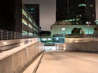 a person on an empty ramp with traffic lights on in a dark city area at night