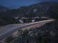 the highway in the mountains is very long exposure at night with long exposures as well