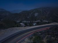 the highway in the mountains is very long exposure at night with long exposures as well