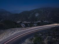 the highway in the mountains is very long exposure at night with long exposures as well