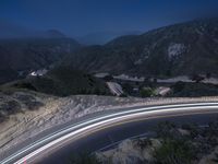 the highway in the mountains is very long exposure at night with long exposures as well