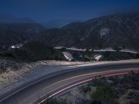 the highway in the mountains is very long exposure at night with long exposures as well