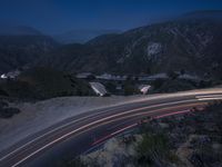 the highway in the mountains is very long exposure at night with long exposures as well