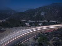 the highway in the mountains is very long exposure at night with long exposures as well