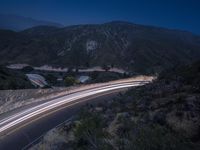 the highway in the mountains is very long exposure at night with long exposures as well