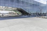 a very long parking garage with many windows and a walkway area underneath it to catch cars and drive by