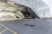 a very long parking garage with many windows and a walkway area underneath it to catch cars and drive by