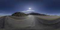 a long winding road with a sunny sky in the background in the middle of the image