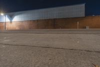 a night shot of a deserted building with lights on and no one on the street