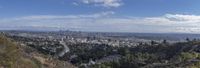 the view of hollywood from above the mountain valley on a sunny day with a clear sky