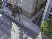 a bird's eye view of the sidewalk on a city street with cars driving down it