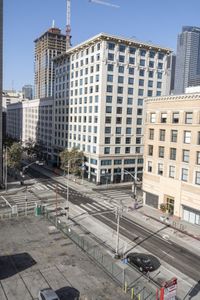 a parking lot has two parking meter and two red telephone booths in it, the city behind it