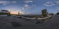 a fish - eye view of the mountains and a big clock tower at sunrise time