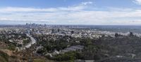 the view of los from atop of a hill near an airport is pictured in this image