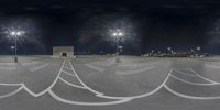 an airport is pictured at night from the street level with many markings around it and light poles