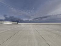 a runway of an airport with multiple runways and clouds in the sky during a storm