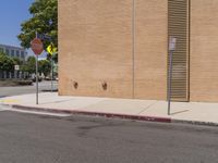 a stop sign is on the side of the street next to a building with a stop sign at it