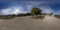 the large sand hill has a bench near it on it, and a sky background