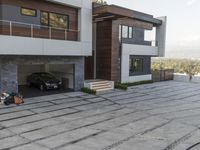 the exterior and landscape of a modern house in los angeles, california with stone and wood