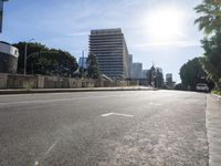 the street is empty with no people on it in the daytime hours, the sun shines brightly