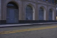 an image of a fire hydrant sitting in the grass outside of an apartment complex