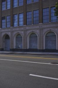 an image of a fire hydrant sitting in the grass outside of an apartment complex