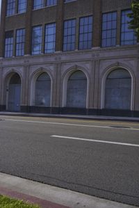 an image of a fire hydrant sitting in the grass outside of an apartment complex